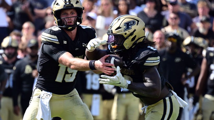 Purdue quarterback Ryan Browne hands off to Fame Ijeboi against Wake Forest