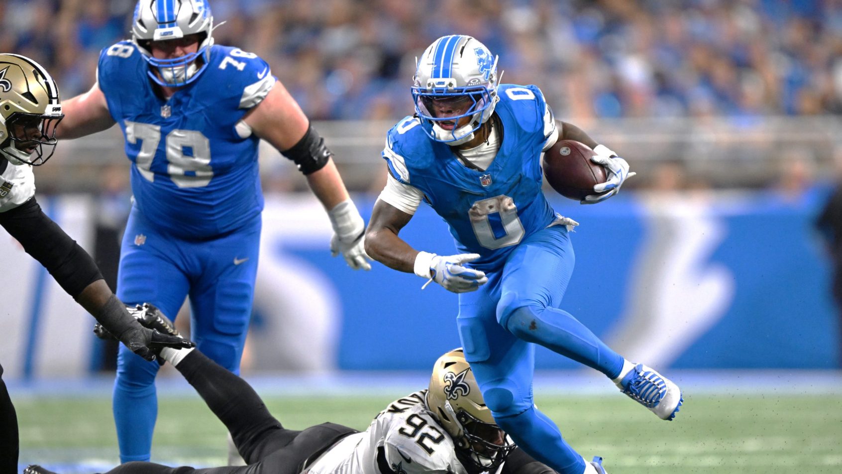 Jahmyr Gibbs breaks a tackle vs the Saints.