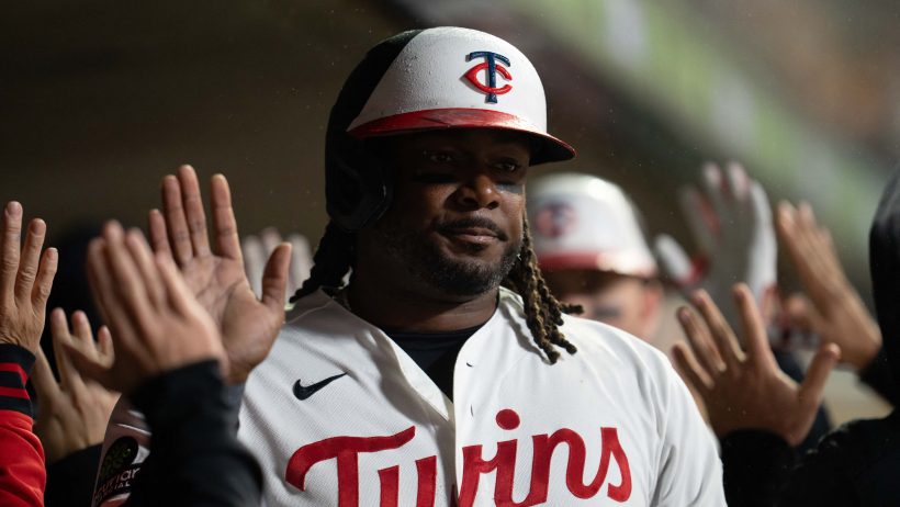 Josh Bell celebrates in the Twins dugout.