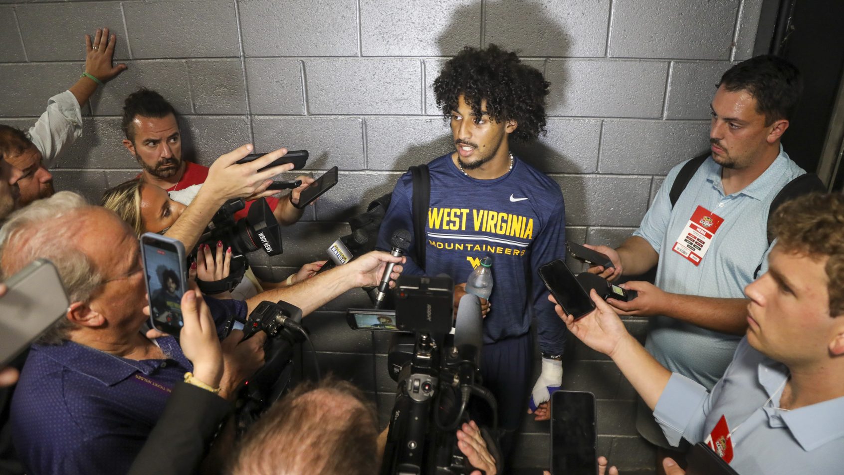 West Virginia quarterback Michael Hawkins Jr. speaks with reporters after the Virginia game
