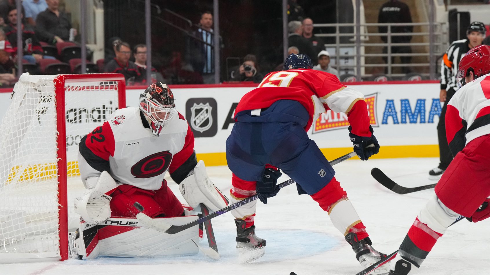 Brandon Bussi stops Matthew Tkachuk in a preseason game.