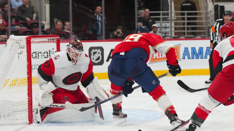 Brandon Bussi stops Matthew Tkachuk in a preseason game.