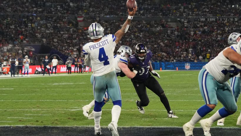 Dallas Cowboys quarterback Dak Prescott throwing a pass