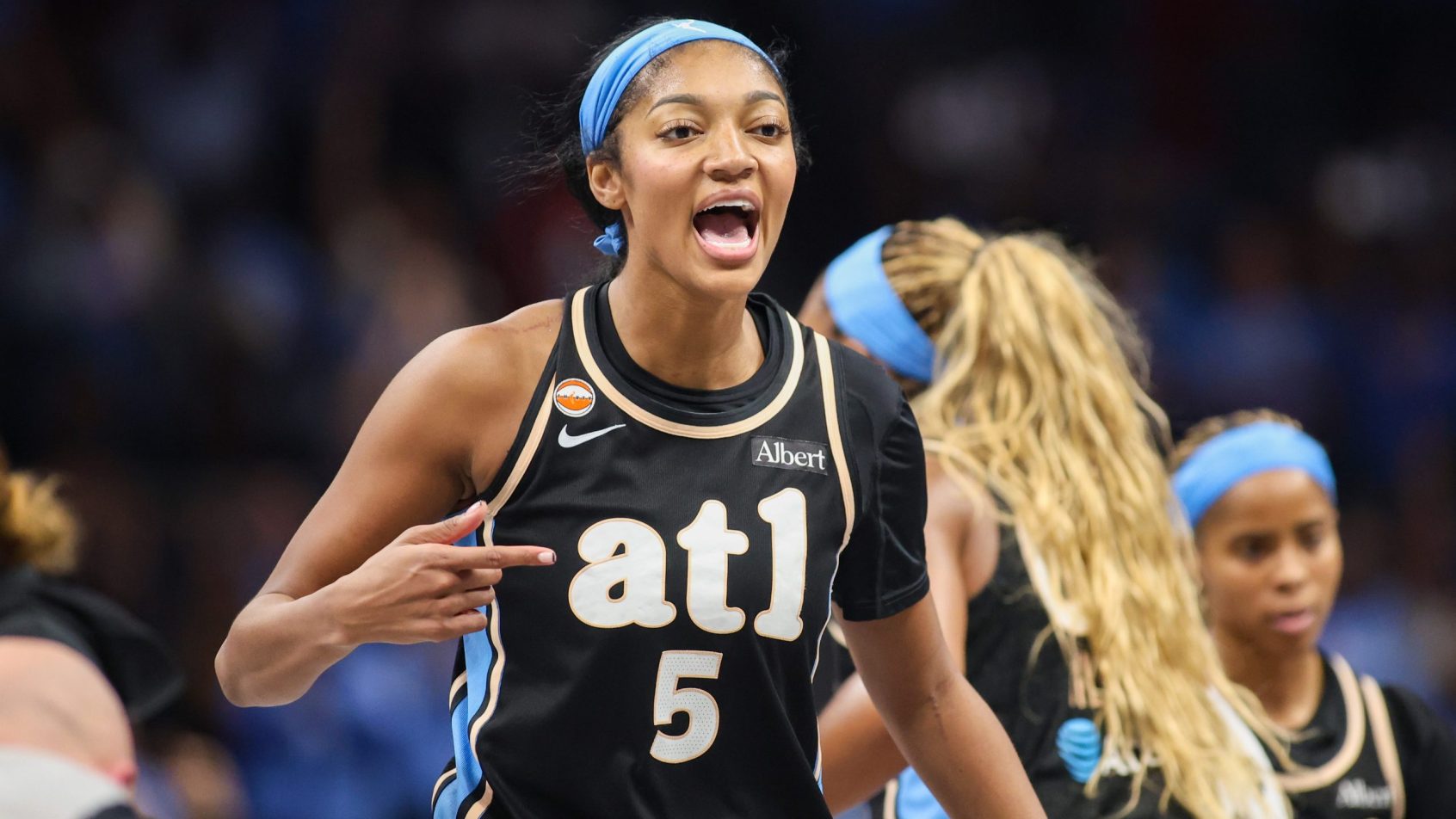 Angel Reese during a timeout in the Dream's Game 1 win over the Mystics.