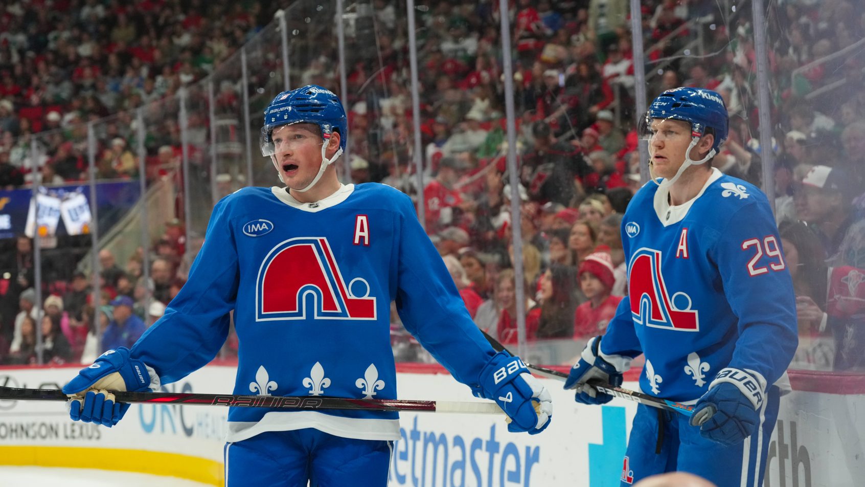 Cale Makar and center Nathan MacKinnon wait for the game to start.