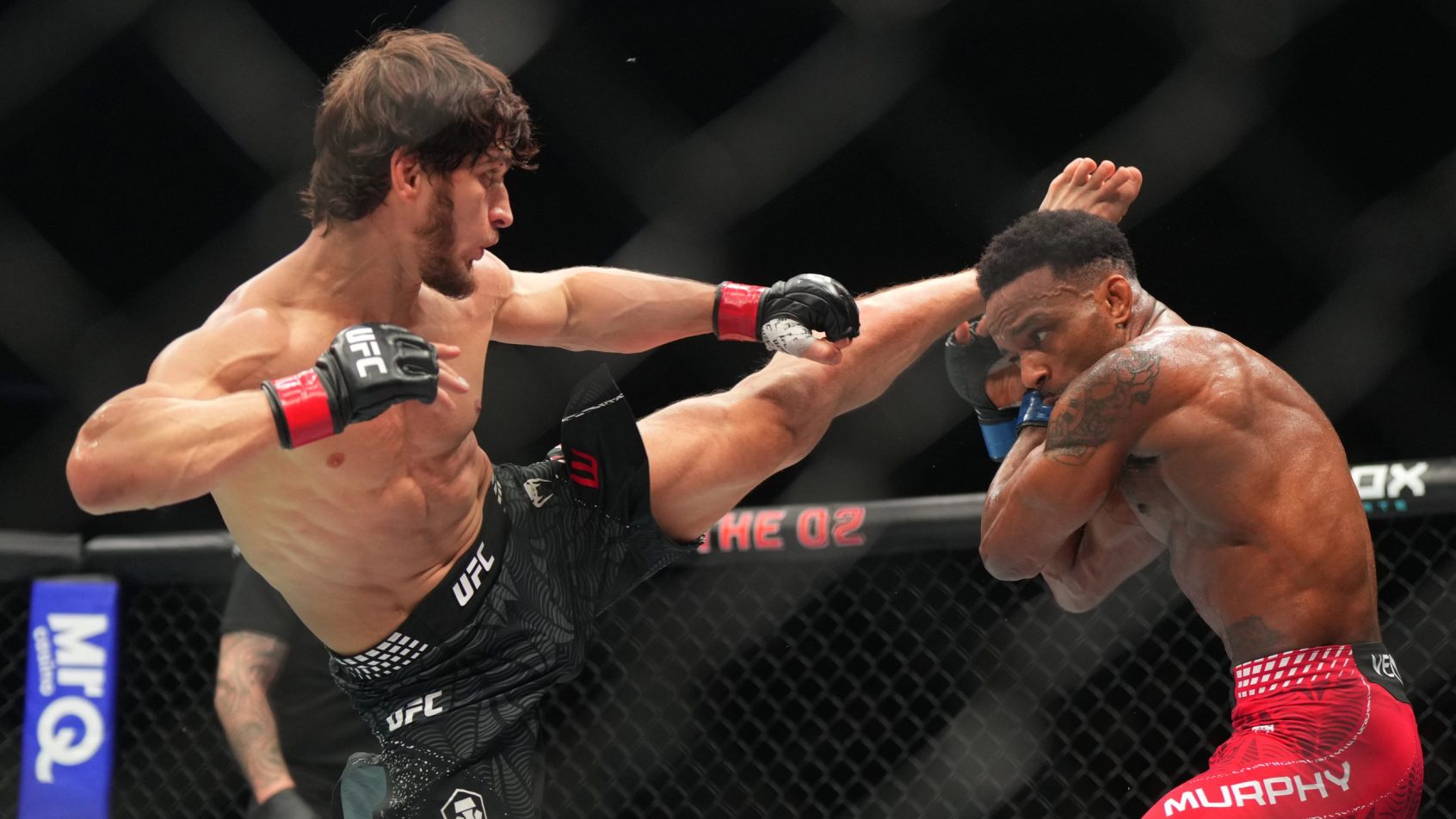 Movsar Evloev launches a kick towards Lerone Murphy's head.
