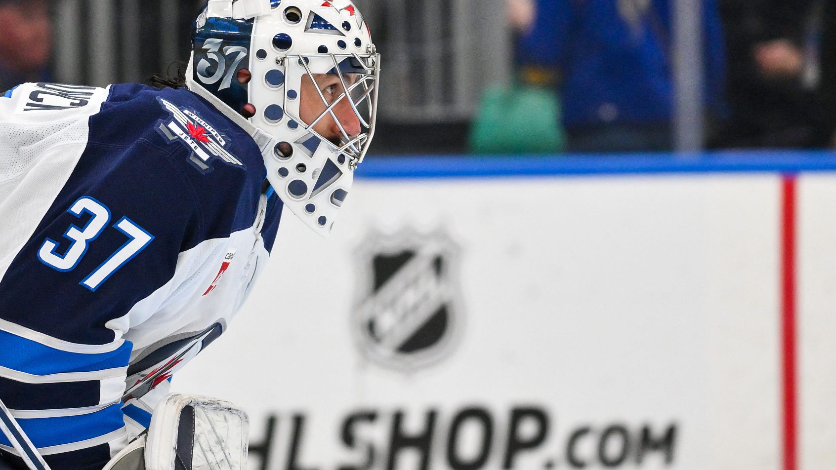 Close-up of Connor Hellebuyck in his Winnipeg Jets mask before his trade to the New Jersey Devils