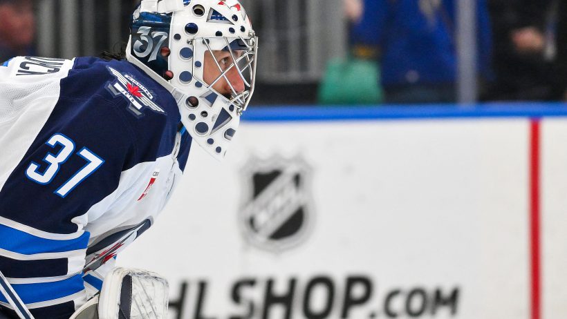 Close-up of Connor Hellebuyck in his Winnipeg Jets mask before his trade to the New Jersey Devils