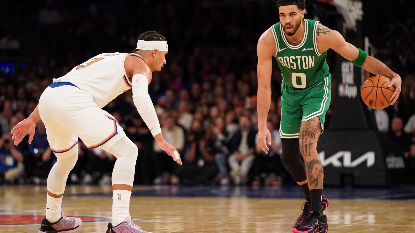 New York Knicks guard Josh Hart defends Boston Celtics forward Jayson Tatum.