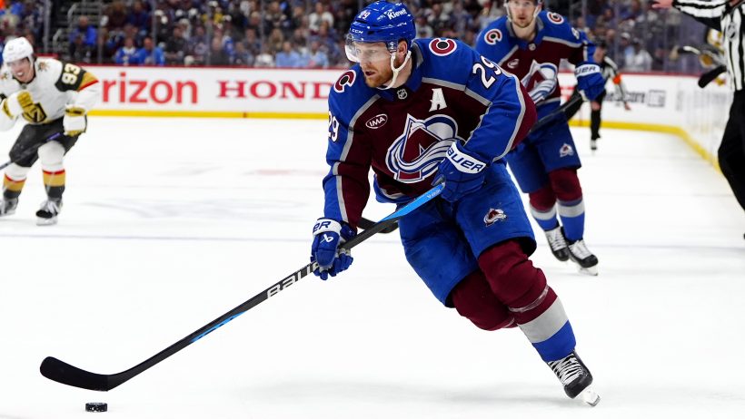 Nathan MacKinnon skates with the puck.
