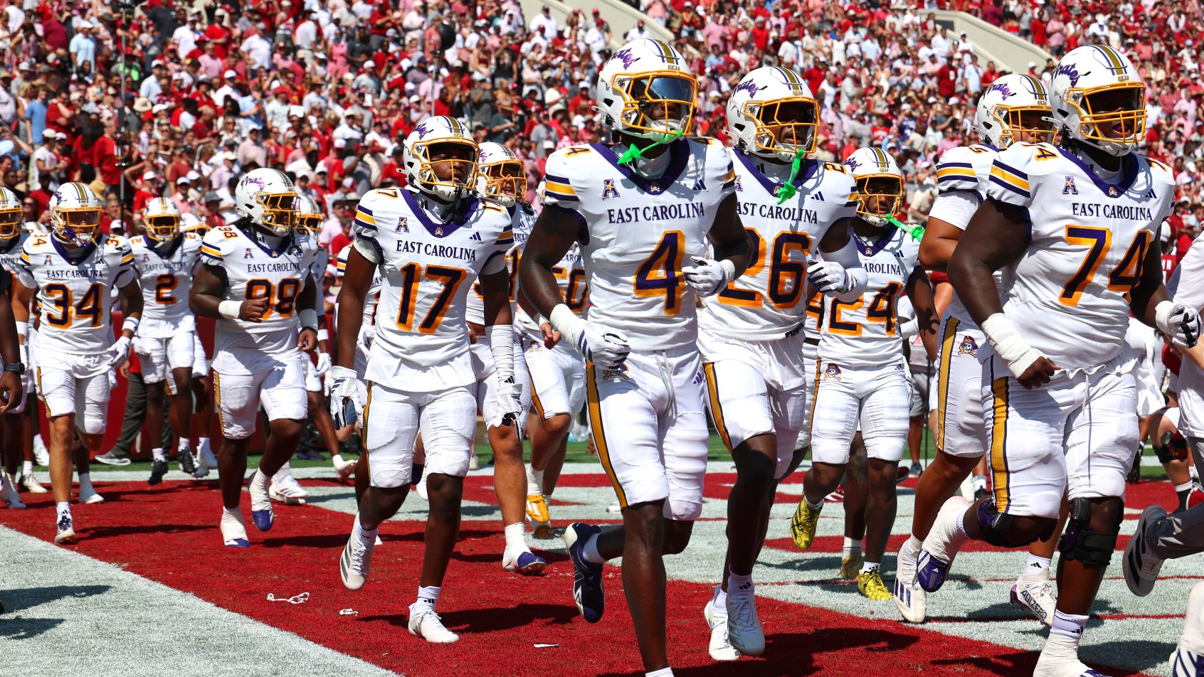 The East Carolina Pirates run onto the field before taking on Alabama.