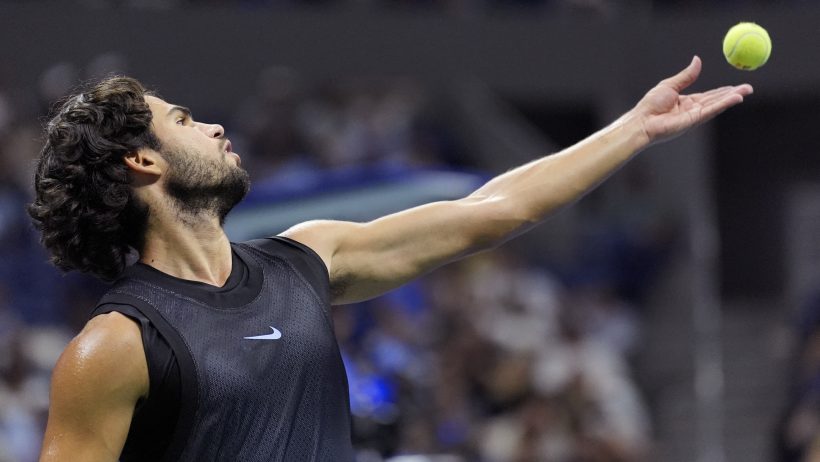 Carlos Alcaraz serves during a US Open match against Ben Shelton.