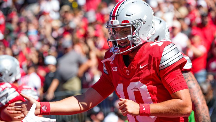 Ohio State quarterback Julian Sayin celebrates a touchdown against Illinois