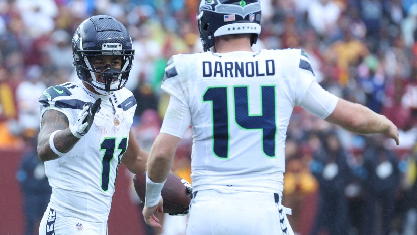 Jaxon Smith-Njigba celebrates a catch with quarterback Sam Darnold