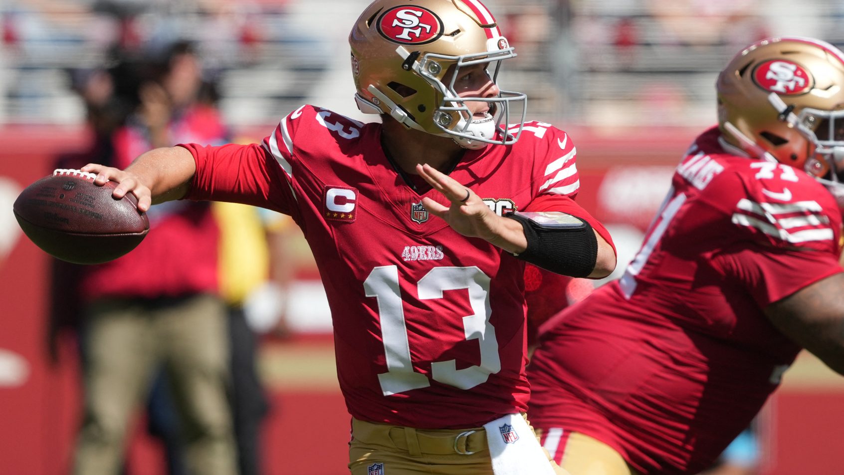 Brock Purdy fires a pass against the Cardinals.