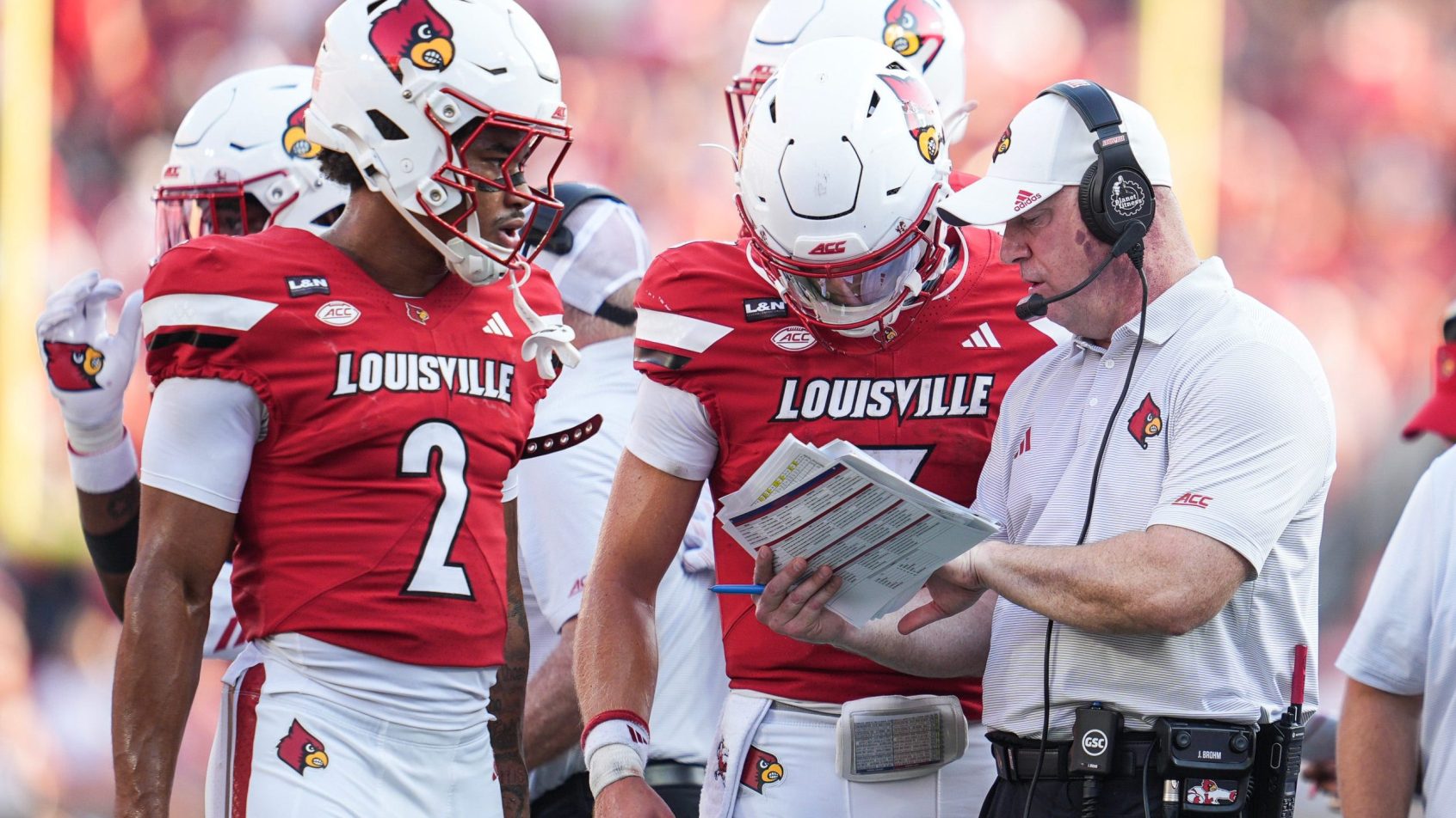Louisville discusses a play during a timeout.