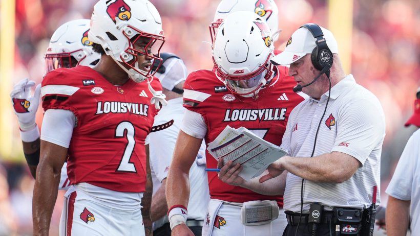 Louisville discusses a play during a timeout.