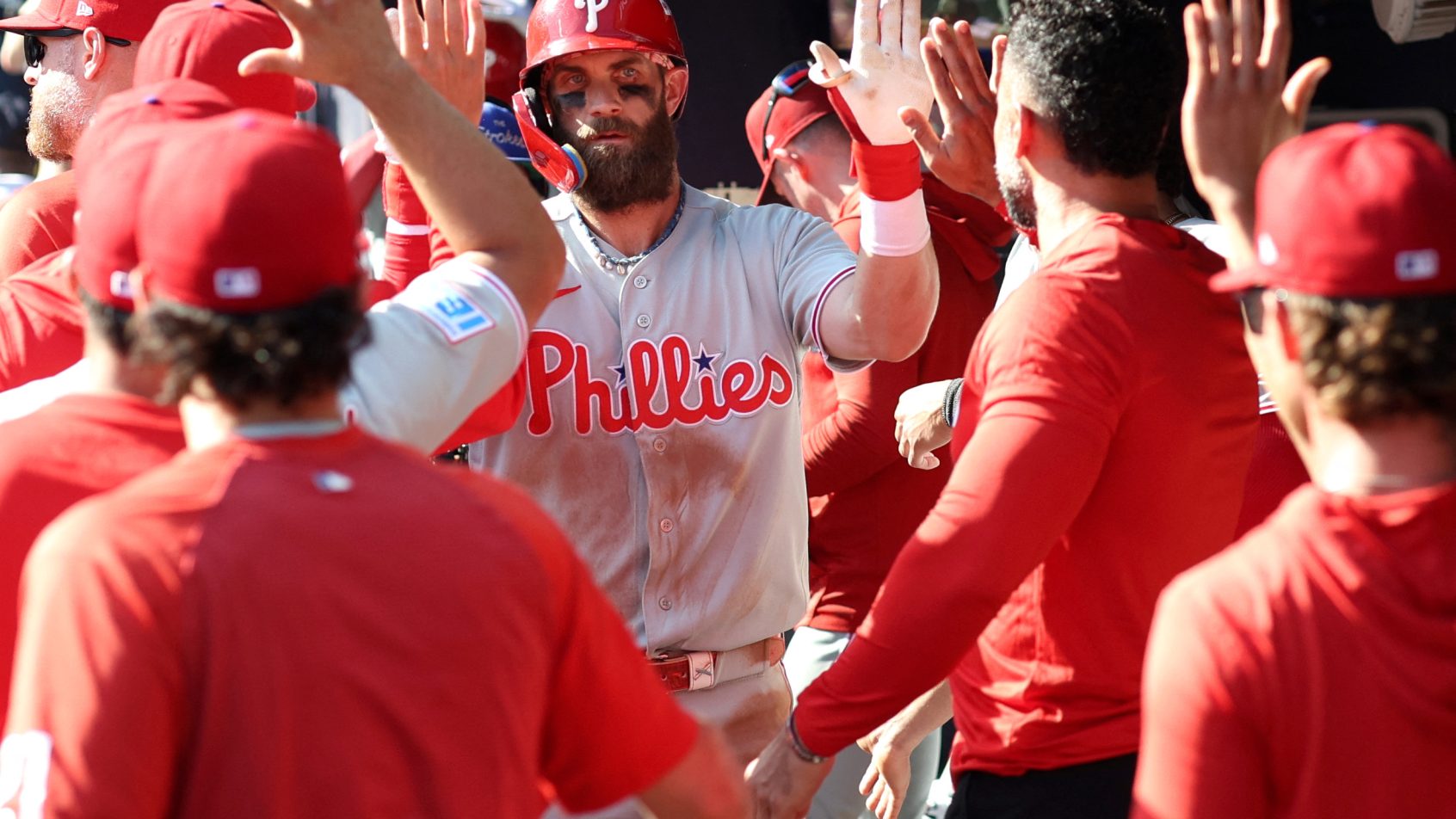 Bryce Harper high-fiving teammates
