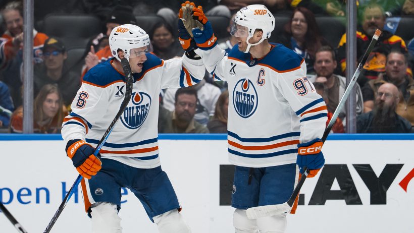 Connor McDavid celebrates an Oilers goal with Ryan Shea.