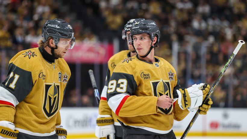 Mitch Marner talks strategy with a teammate before a faceoff.