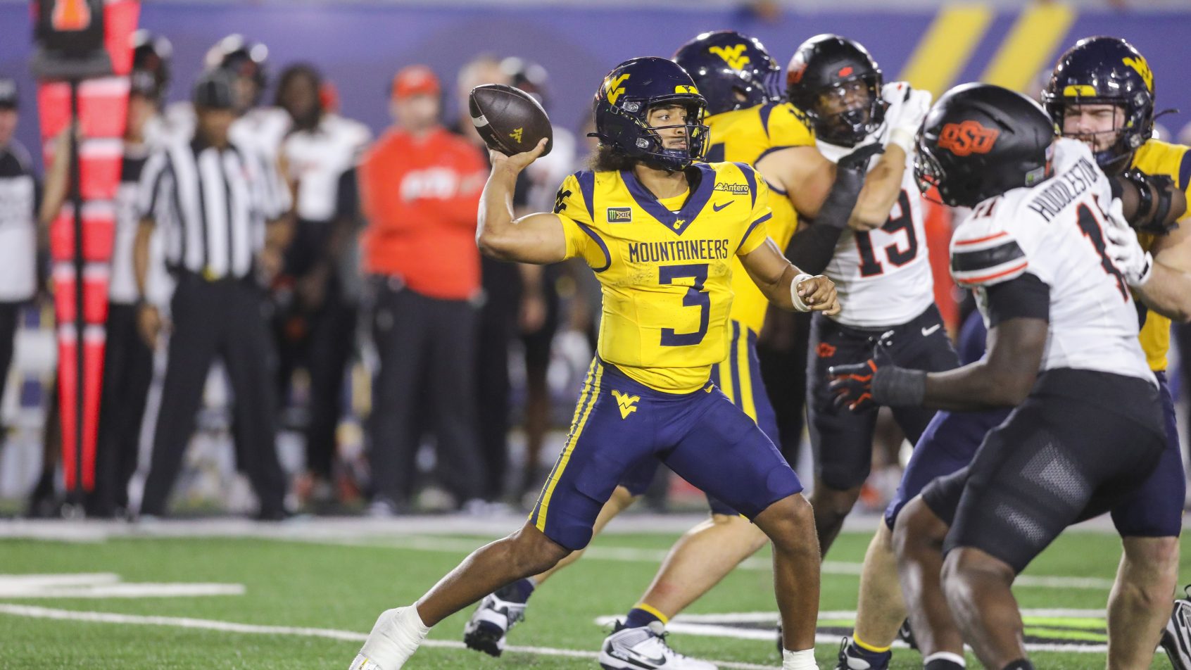 West Virginia quarterback Michael Hawkins Jr. throws against Oklahoma State