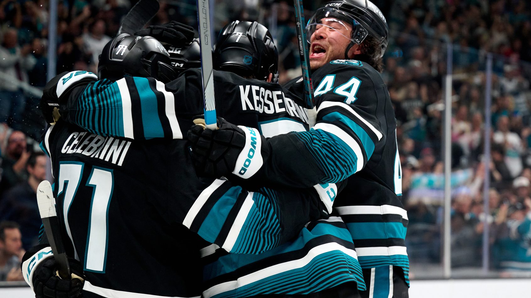 Macklin Celebrini and San Jose Sharks teammates celebrate an overtime-winning goal