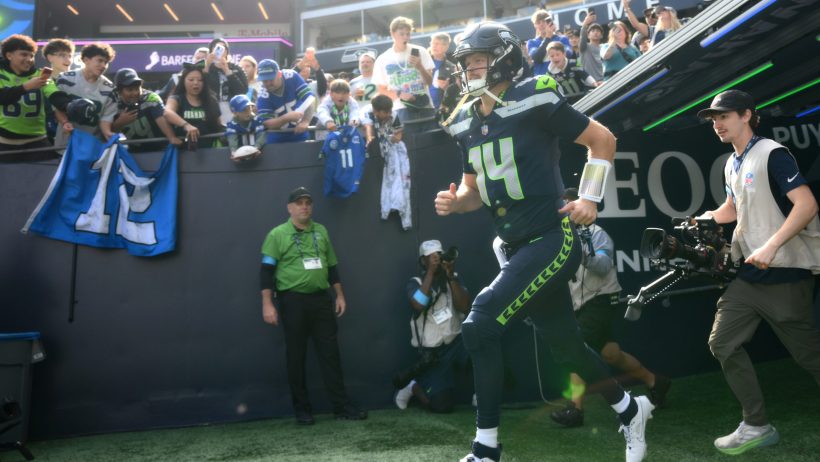 Sam Darnold runs onto the field for a game against the Chargers.