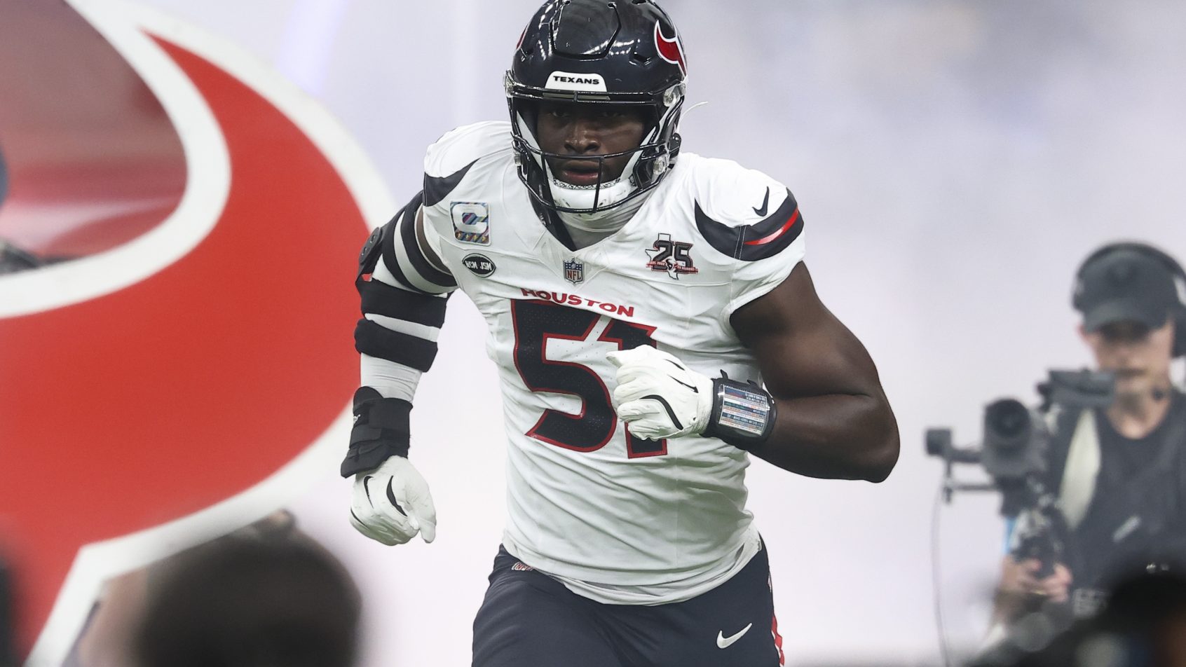 Houston Texans defensive end Will Anderson Jr running onto the field