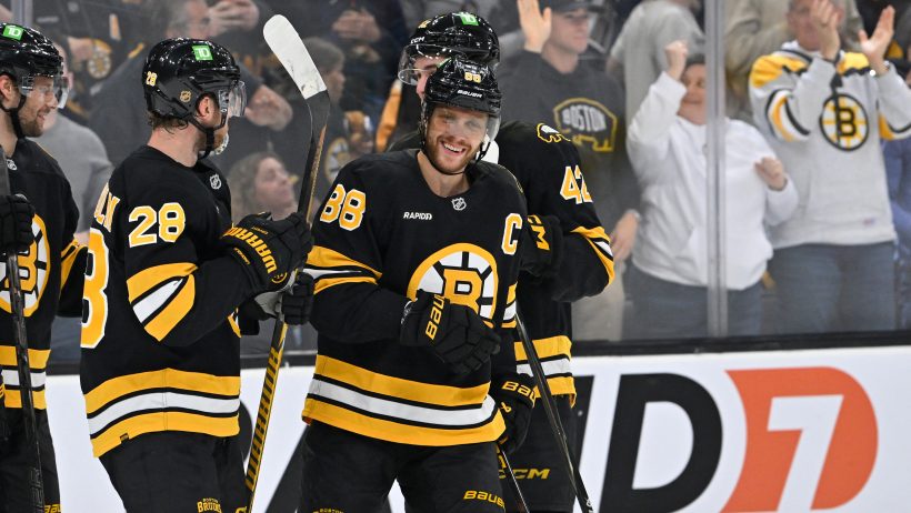 David Pastrnak celebrates with teammates.
