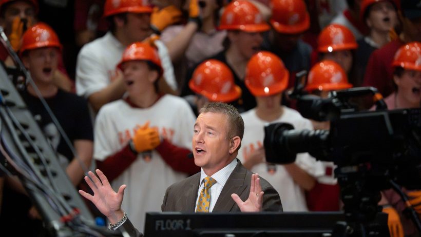 Kirk Herbstreit speaks on the College GameDay set with college football fans behind him
