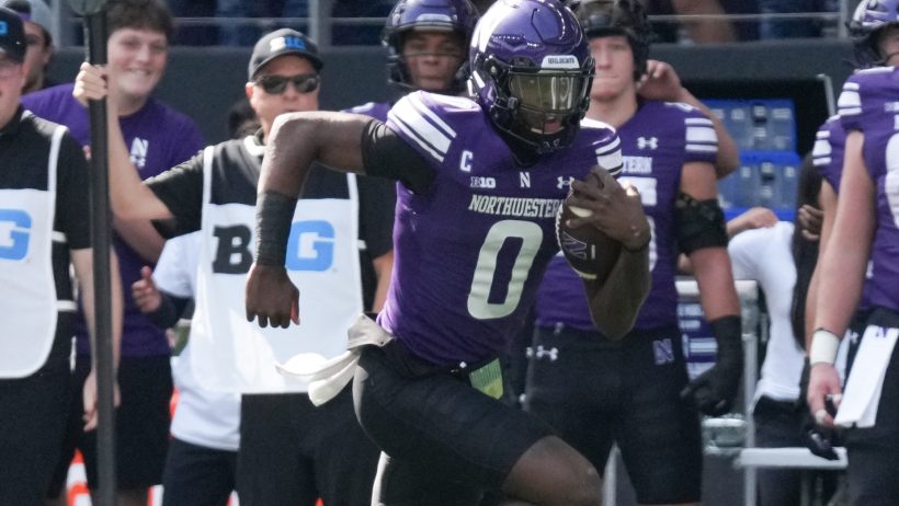 Northwestern quarterback Aidan Chiles carries the ball against Ball State