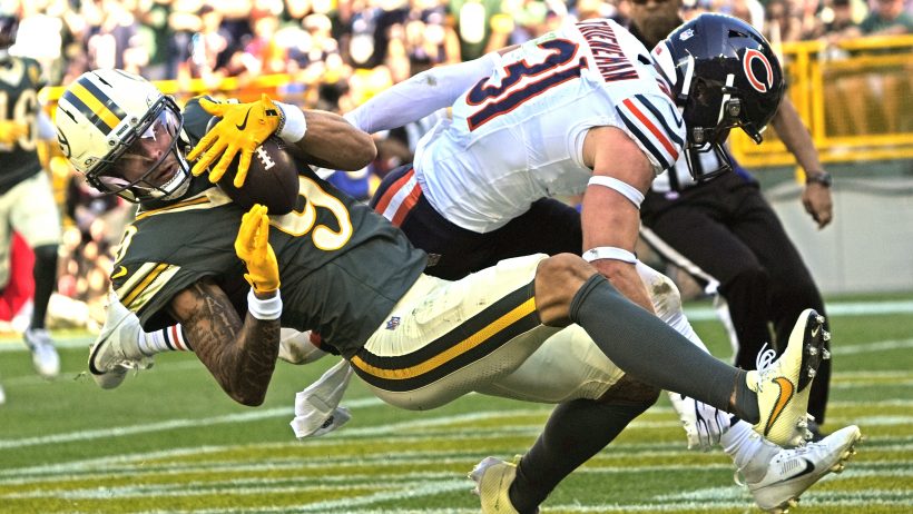Christian Watson catches a touchdown against the Chicago Bears at Lambeau Field