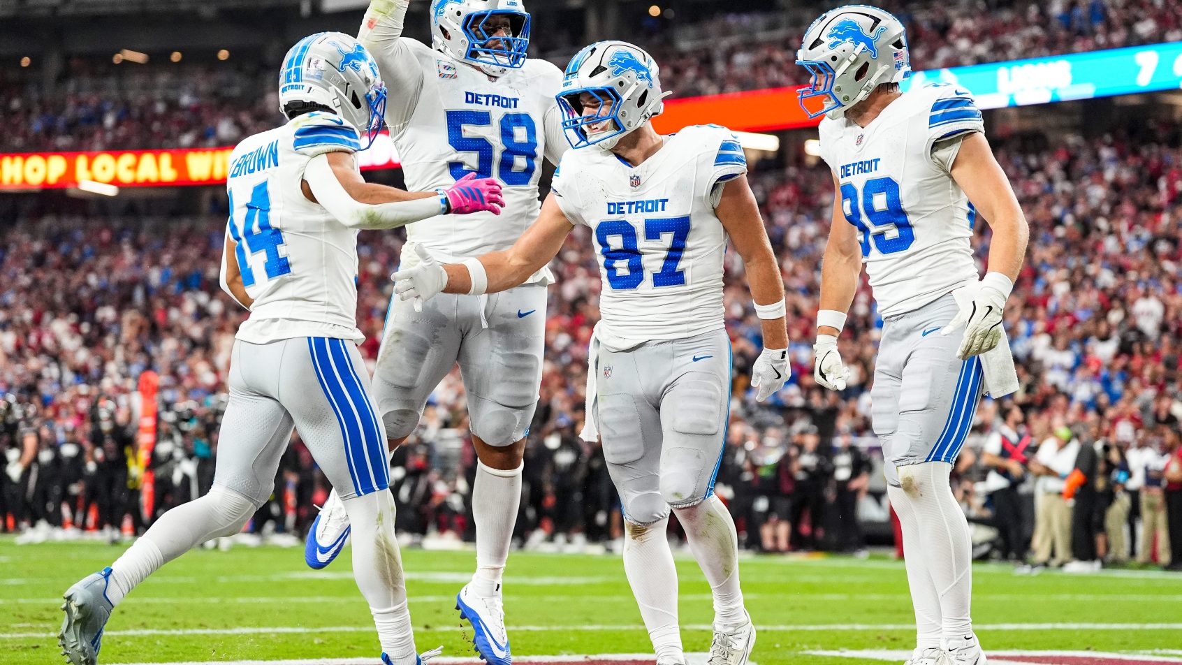 Detroit Lions players celebrating a touchdown in the 2026 NFL season.