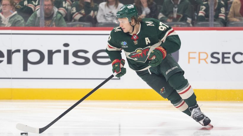 Kirill Kaprizov skates with the puck.