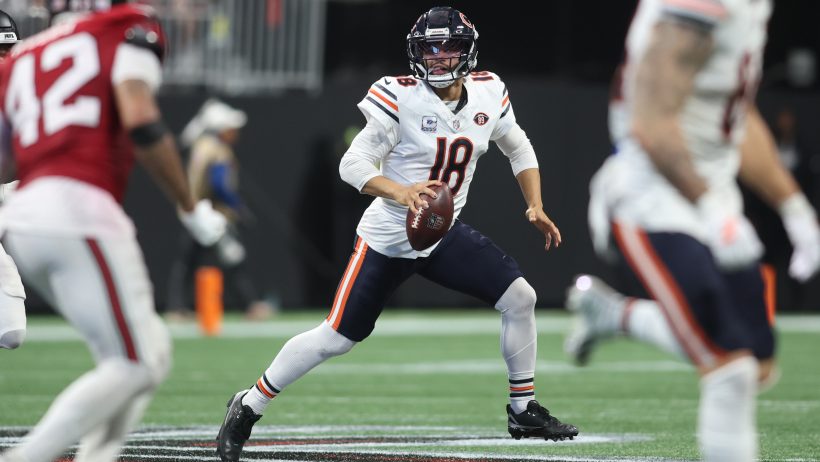 Chicago Bears quarterback Caleb Williams rolling out of the pocket