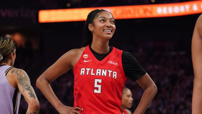 Angel Reese smiles before heading to the free throw line.