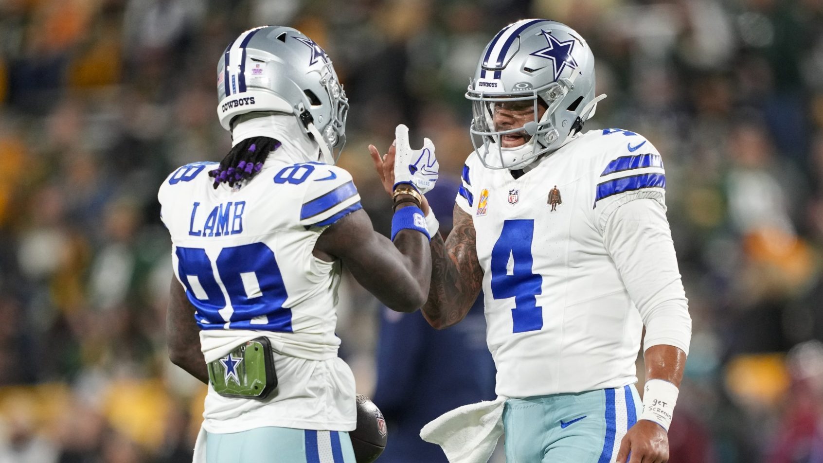Dak Prescott and CeDee Lamb celebrate during a game vs the Packers.