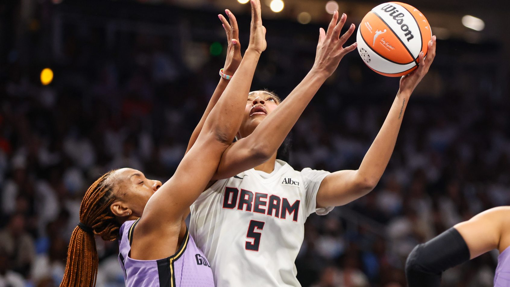 Angel Reese tries to shoot over a Golden State defender in the WNBA Finals.
