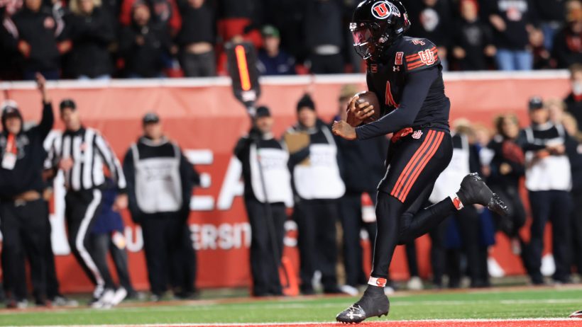 Utah quarterback Devon Dampier scores a touchdown against Houston
