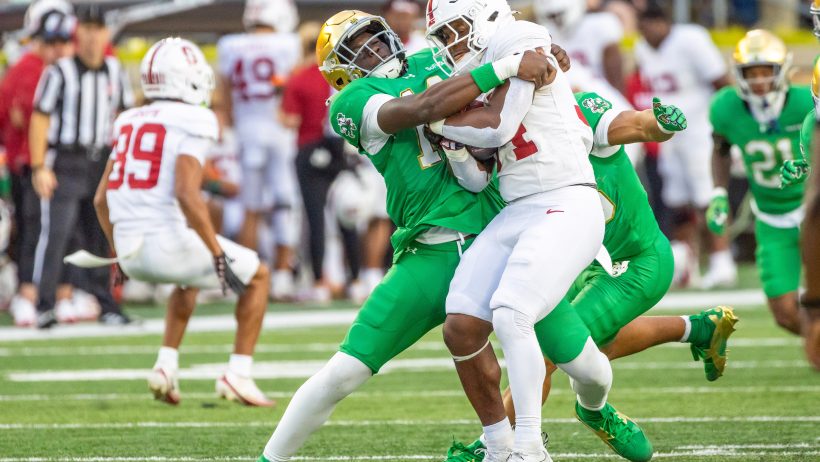 Notre Dame defensive lineman Ebenezer Ewetade tackles Stanford running back Champ Hampton