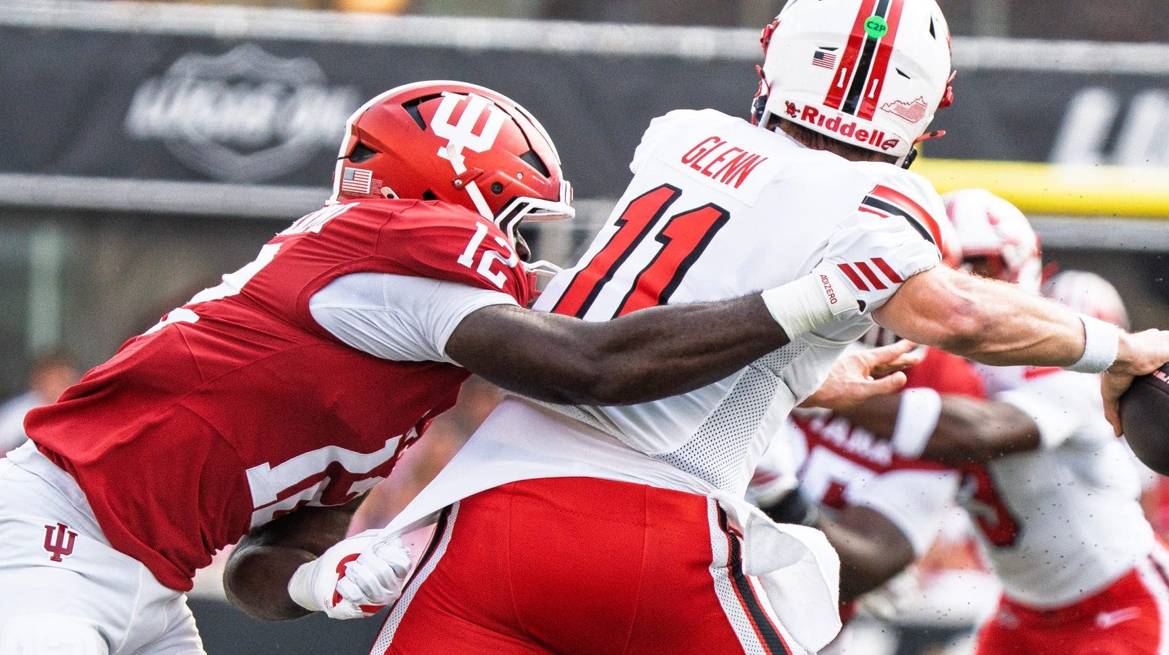 Western Kentucky quarterback Brock Glenn avoids an Indiana defender