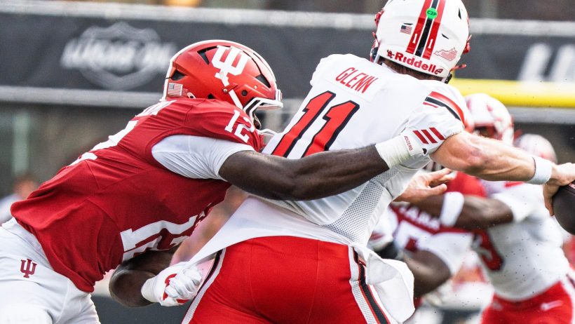 Western Kentucky quarterback Brock Glenn avoids an Indiana defender