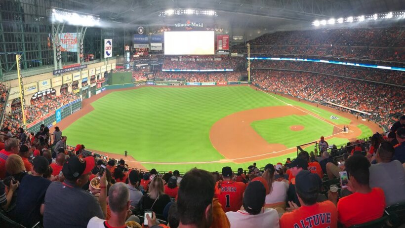 A baseball diamond with fans cheering in it