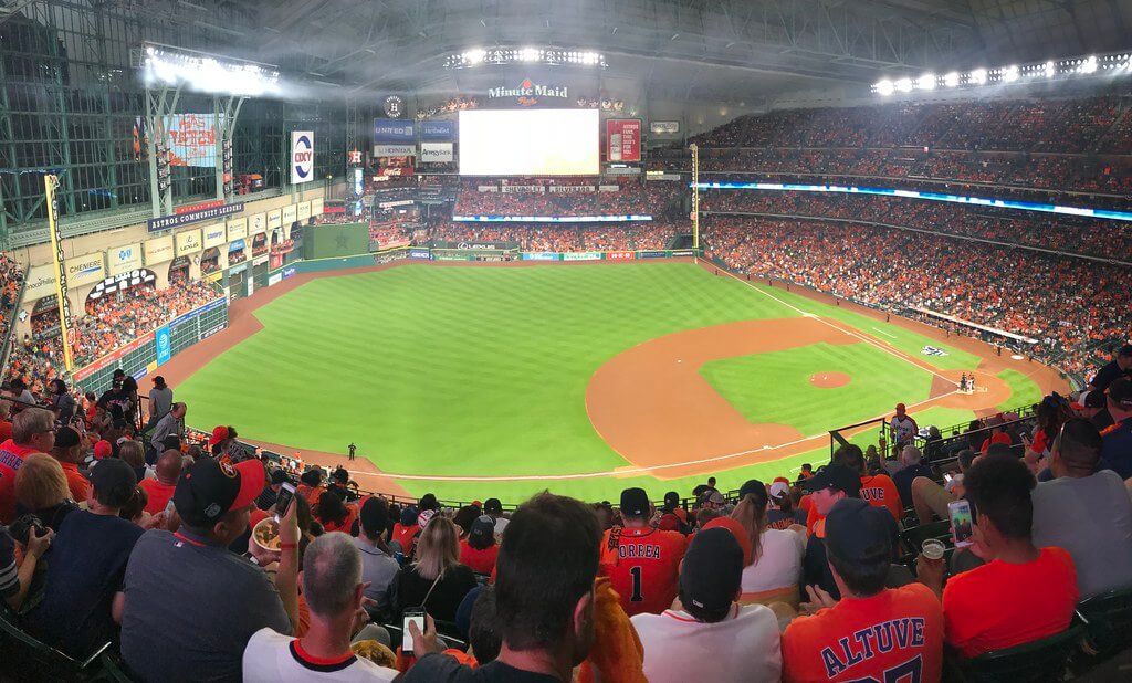 A baseball diamond with fans cheering in it