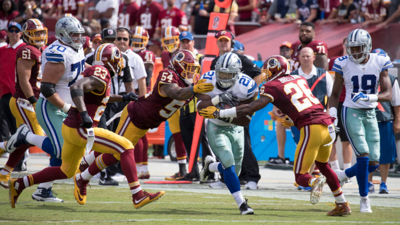 Ezekiel Elliott of the Dallas Cowboys running through arm-tackles