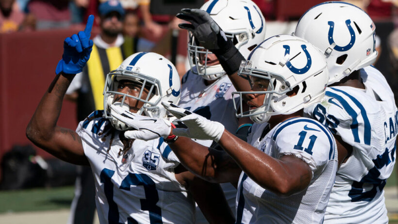 Colts players motioning with their hands