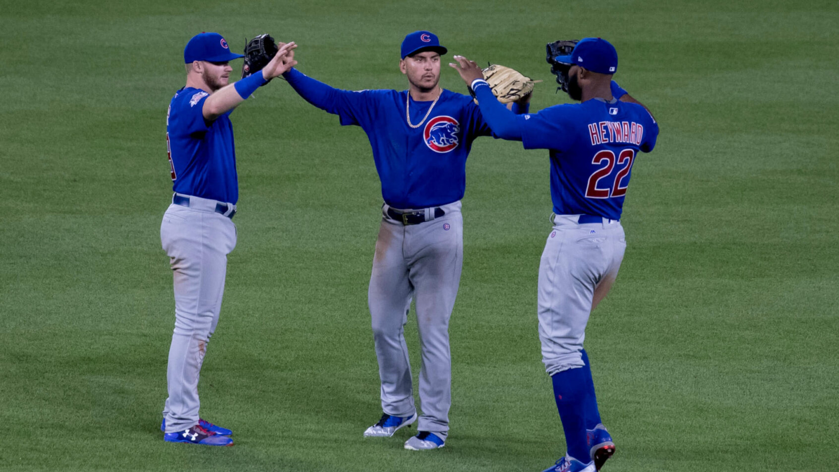 Chicago Cubs outfielders celebrating a win.