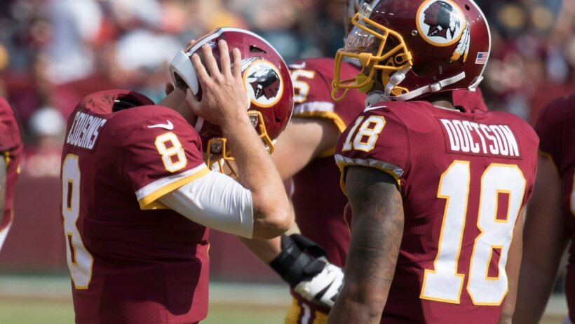 Kirk Cousins holding his helmet
