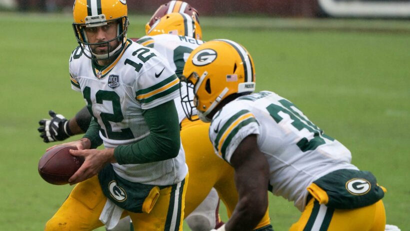 Aaron Rodgers hands off to Jamaal Williams