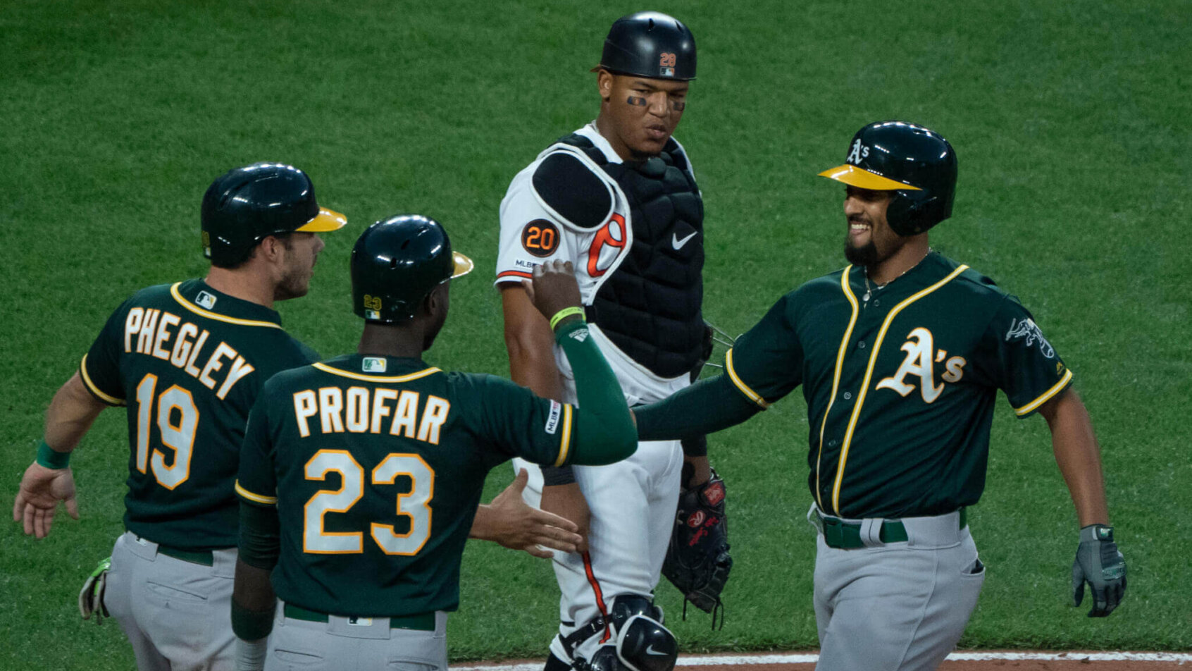 Oakland A's celebrate a run against Baltimore.